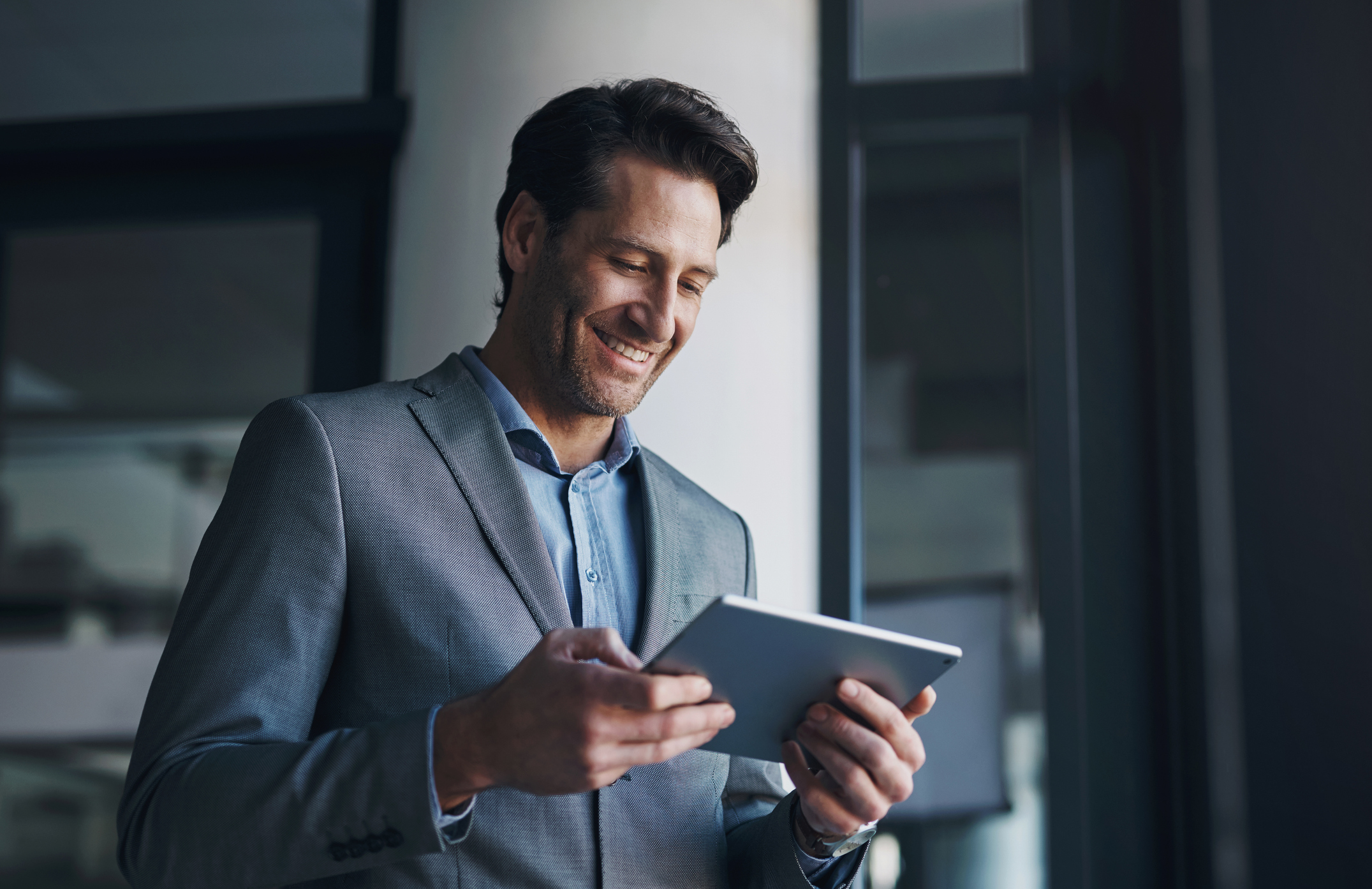 Happy CFO reviewing data on a tablet